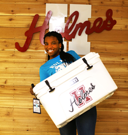Ariel Wolfe, a Holmes alumna, who recently won a social media giveaway from Holmes. Wolfe won the Yeti cooler by sharing Holmes' 90th birthday video.