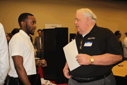 Pictured is (right) Ken Lowery, human resources manager for Hunter Engineering Company in Durant, speaking with Holmes student and SkillsUSA member Gavan Redfield about job opportunities at the Second Annual Career Fair held in the Holmes Community College McGowan Workforce Training Center in Ridgeland on Feb. 18.